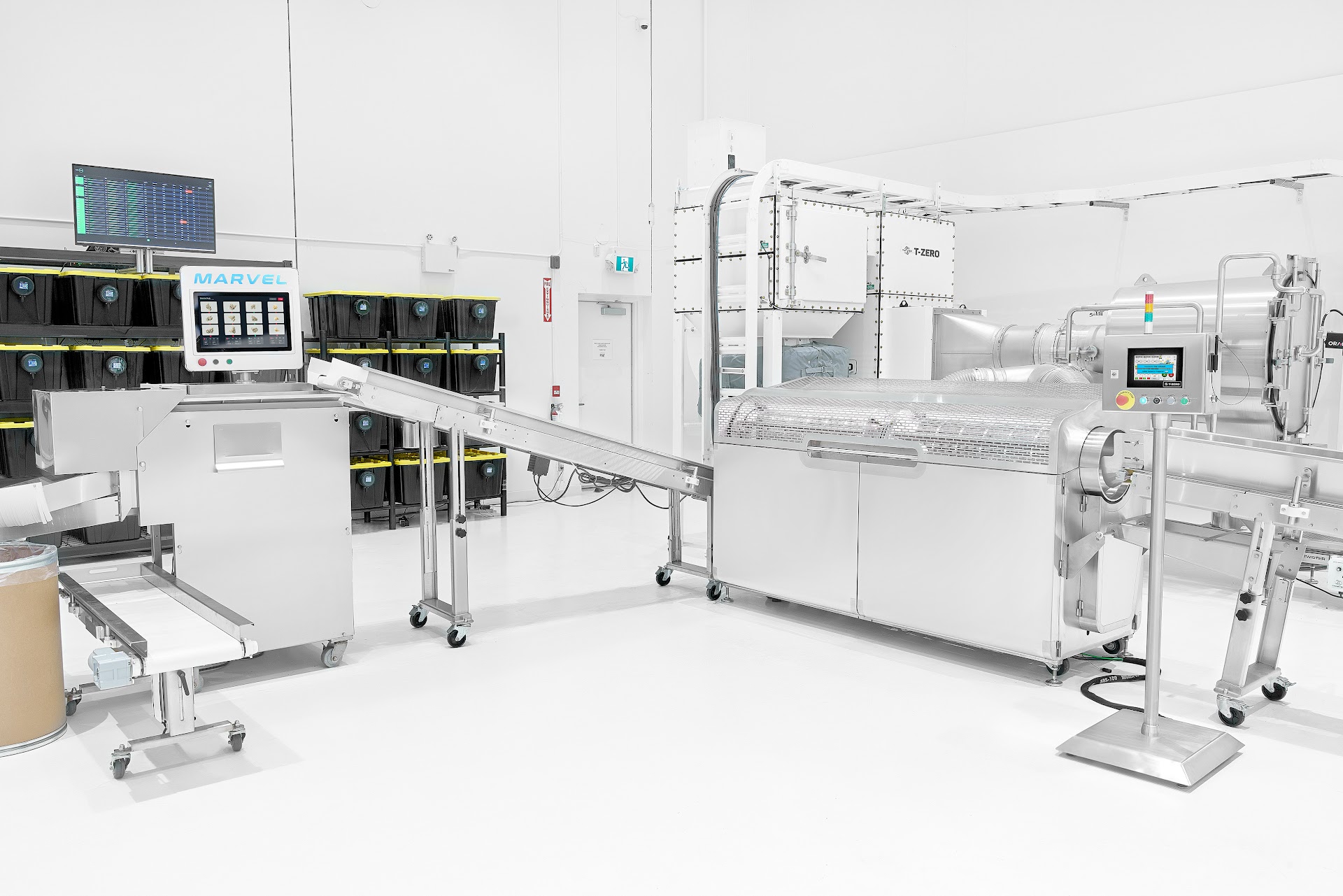 A full Marvel line installed in a GMP facility: infeed conveyor, MARVEL grading terminal, drum sorter, and T-ZERO decontamination unit